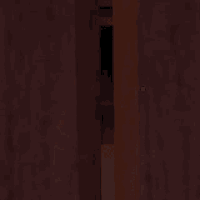a person is walking through a dark room with a glowing object in the background .
