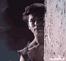 a shirtless man leaning against a wall with a watermark that says rammstein