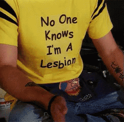 a man wearing a yellow t-shirt that says no one knows i 'm a lesbian