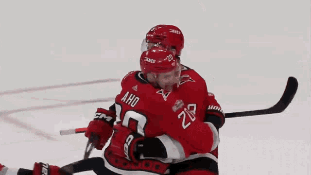 a hockey player with the number 20 on his jersey celebrates with his teammates
