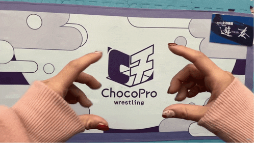 a person holding a chocopro wrestling logo