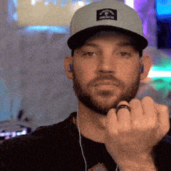 a man with a beard wearing a hat and a ring