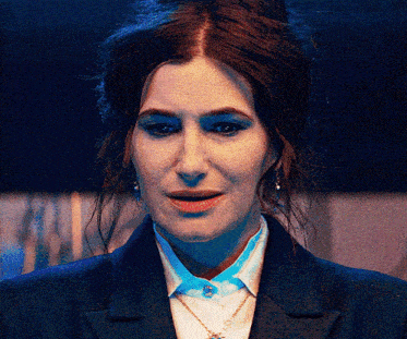 a close up of a woman 's face wearing a blue jacket