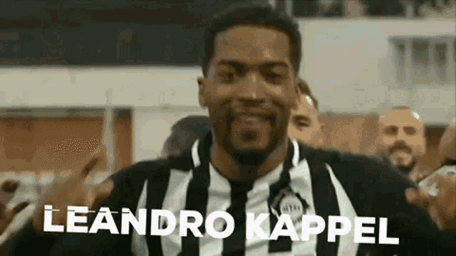 a man in a black and white striped shirt with the name leandro kappel written on it