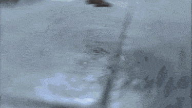 a soldier is running away from an explosion with a sign in the background that says ' coca-cola '
