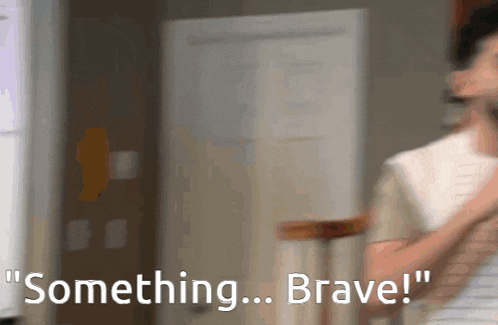a blurry picture of a person holding a piece of paper with the words something brave behind them