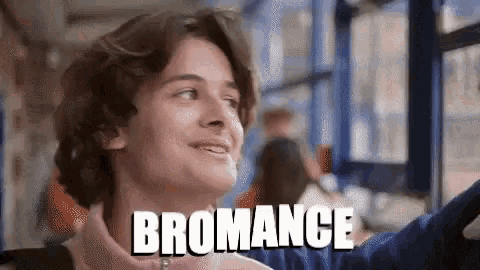a young man is smiling and the word bromance is on the bottom