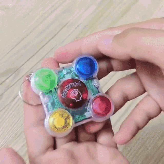 a person is holding a small toy that says memory