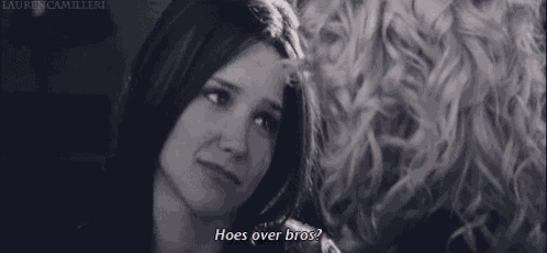 two women are looking at each other and one of them is saying hoes over bros