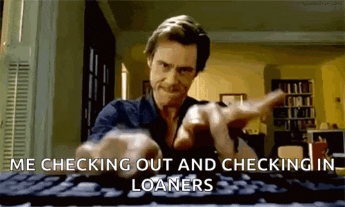 a man is pointing at a keyboard with the words `` me checking out and checking in loaners '' written on it .
