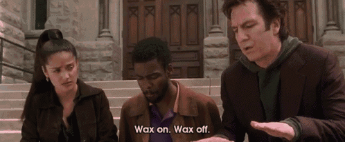 a man says wax on wax off in front of a building