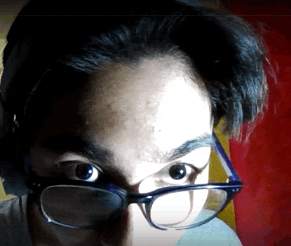 a close up of a person 's face with glasses