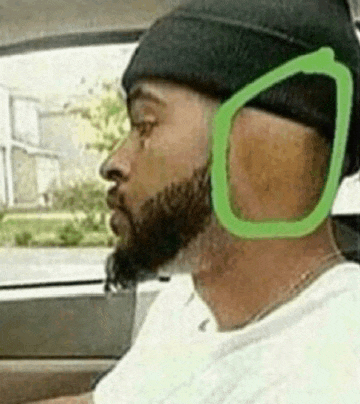 a man with a beard wearing a beanie and headphones .