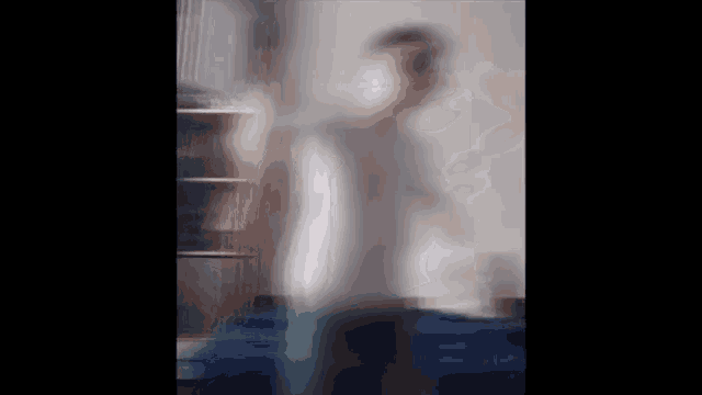 a blurry photo of a person standing in a room