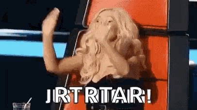 a woman is sitting in a chair with the words jirt rtar written on the screen
