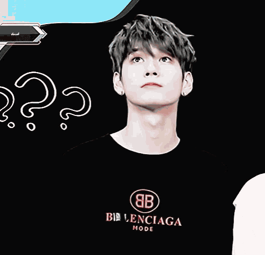 a young man wearing a black balenciaga t-shirt looks up at something