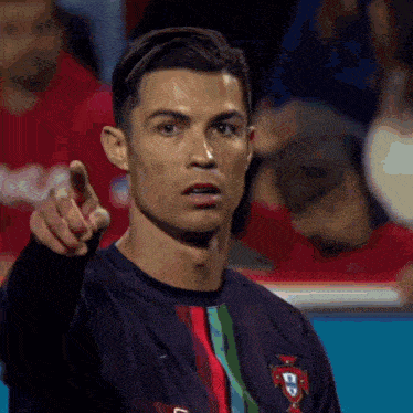 a close up of a man pointing at something