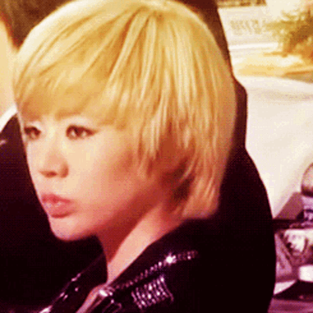 a close up of a woman 's face with blonde hair