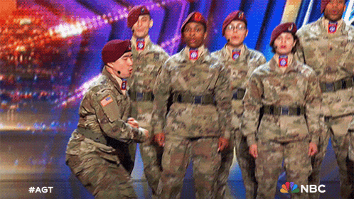 a group of soldiers on a stage with a nbc logo behind them