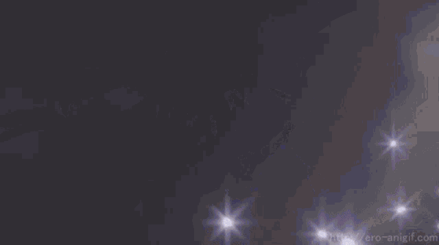 a ring of light is surrounded by a bunch of stars on a dark background .
