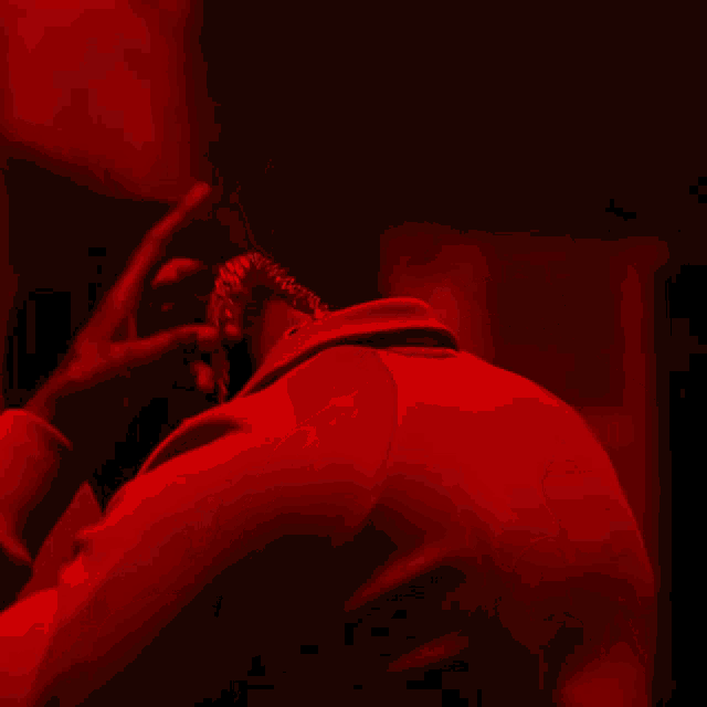 a man in a red jacket is looking down