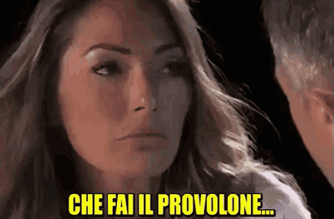 a woman and a man are looking at each other and the woman says che fai il provolone .