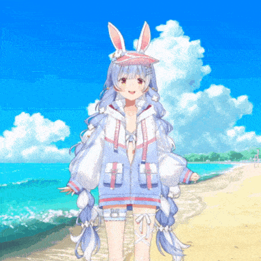 a girl with bunny ears is standing on a beach wearing a jacket that says tokyo ghoul