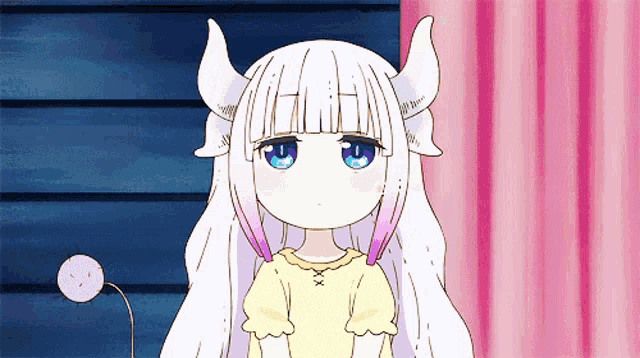 a girl with horns and a tail is looking at the camera