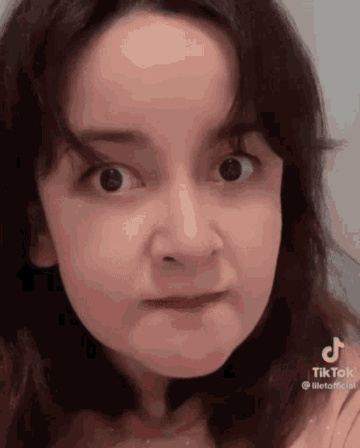 a close up of a woman making a funny face with her mouth open