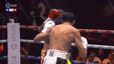 two boxers are fighting in a ring with a sign that says riyadh season