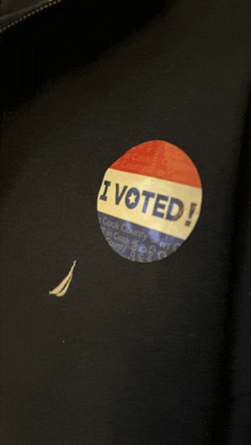 a i voted sticker on a black jacket