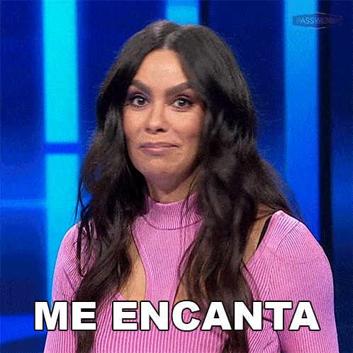 a woman in a pink sweater says me encanta on a blue background