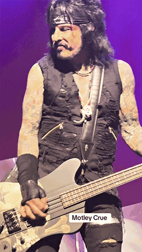 a picture of a man playing a guitar with the name motley crue underneath him