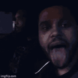 a man sticking his tongue out while another man looks on ..