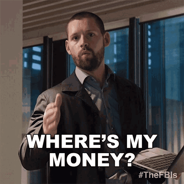 a man is holding a laptop and asking where is my money