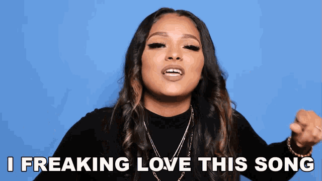 a woman singing with the words i freaking love this song below her