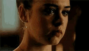 a woman is crying with tears running down her face .