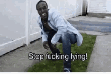 a man squatting down with the words stop fucking lying written on the ground
