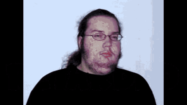 a man with glasses is making a funny face with the word eyyy in red letters