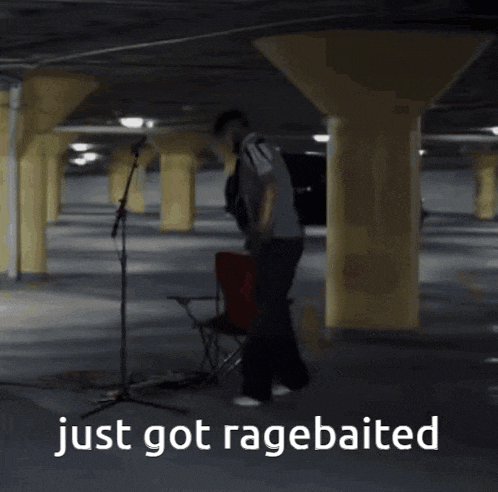 a man playing drums in a parking garage with the words just got ragebaited below him