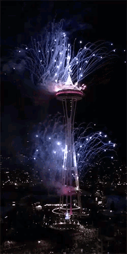 the space needle is lit up with fireworks
