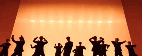 a group of people are standing in front of a stage .