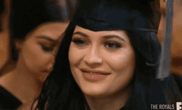 a woman is wearing a graduation cap and smiling .