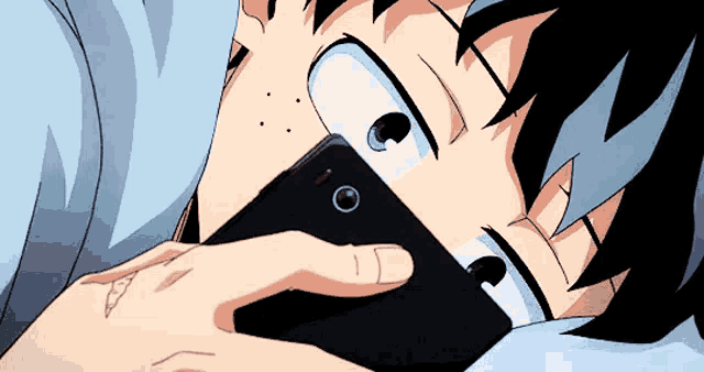 a person is laying in bed with a cell phone in their hand .