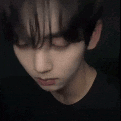 a close up of a man 's face with a black shirt on