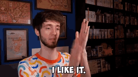 a man says i like it in front of a bookshelf