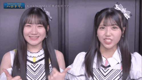 two girls are standing next to each other and one has ocha norma written on her hair