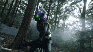 a person in a costume with horns and green eyes