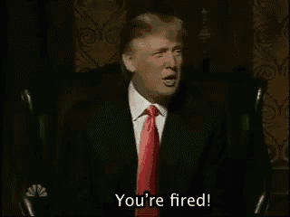 a man in a suit and tie is sitting in a chair and says you 're fired