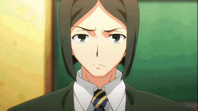 a man in a suit and tie has a serious expression on his face